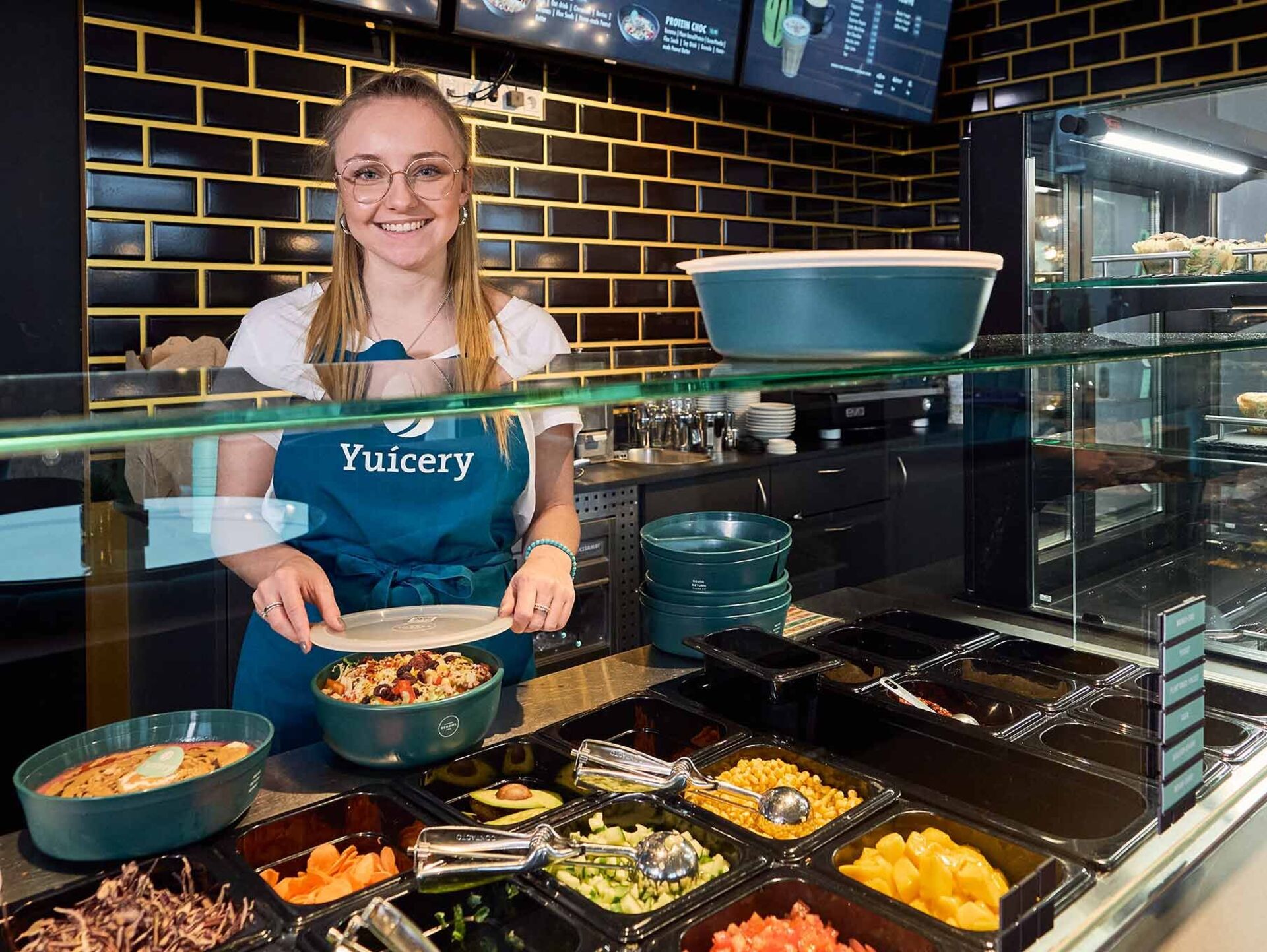 Reuse and refill A catering employee preparing reusable bowls