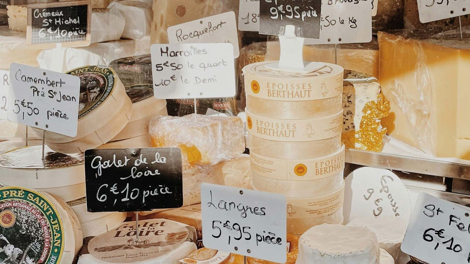 Allowed: Camembert in wooden packaging a refrigerated counter with different types of Camembert in wooden packaging and with price tags