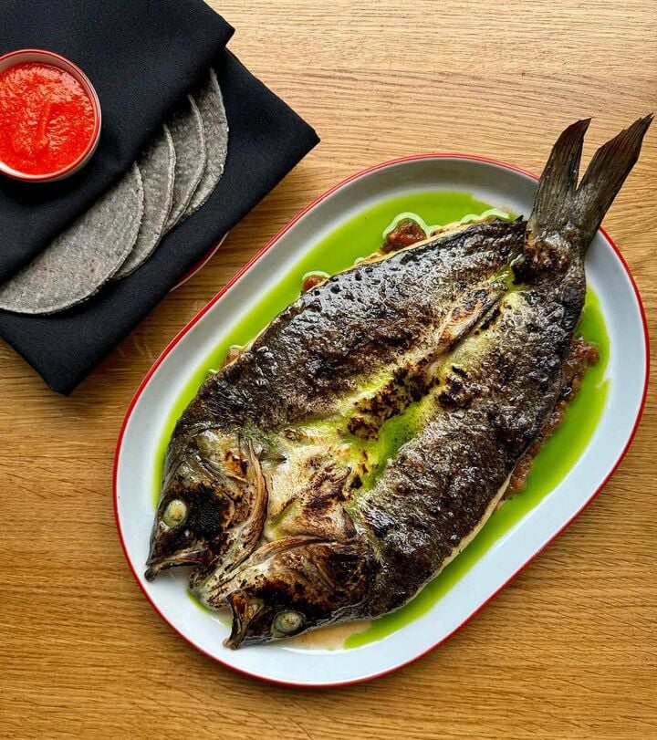 Loup de mer fried in butter and cooked on a wood fire with tatemada sauce and corn tortillas Loup de mer fried in butter and cooked on a wood fire with tatemada sauce and corn tortillas