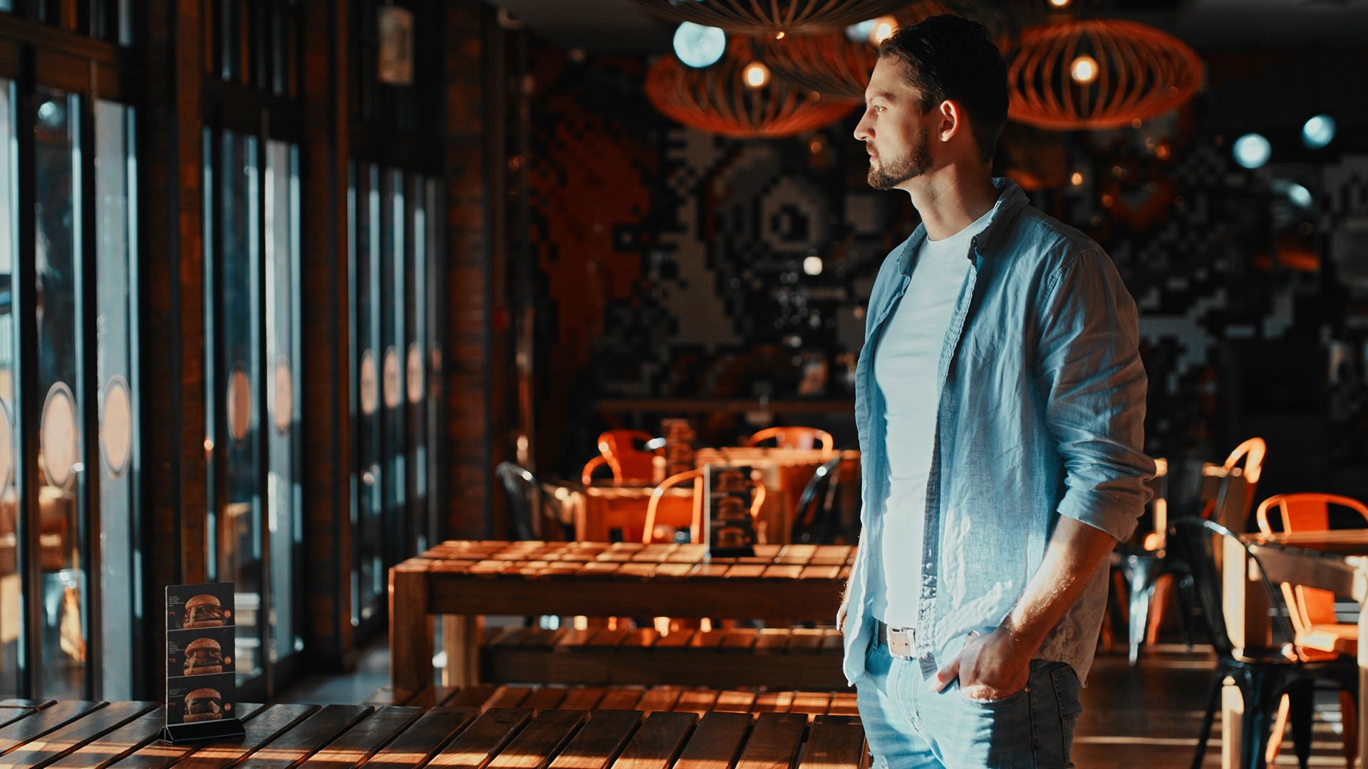 Mistake: immature concept A restaurateur stands in his café and looks thoughtfully outside; there are no guests in the café